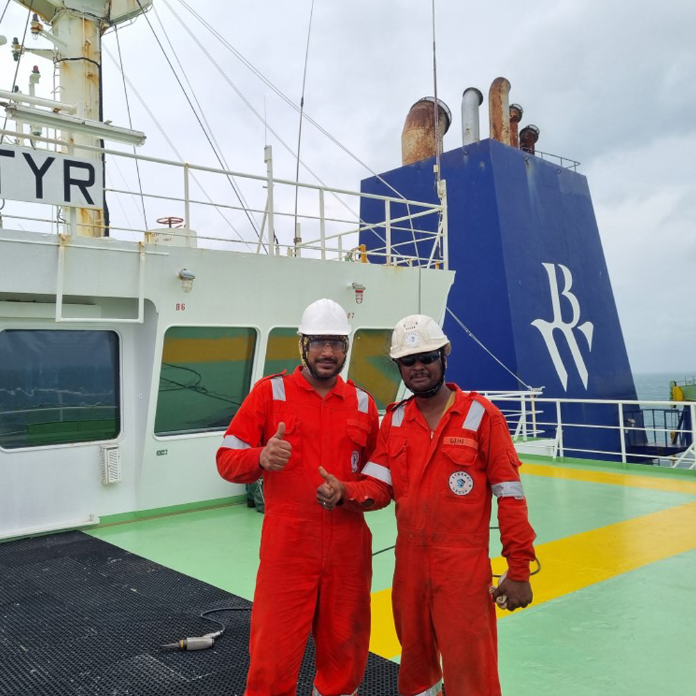 Our seafarers posing in front of the funnel of our LPG vessel
